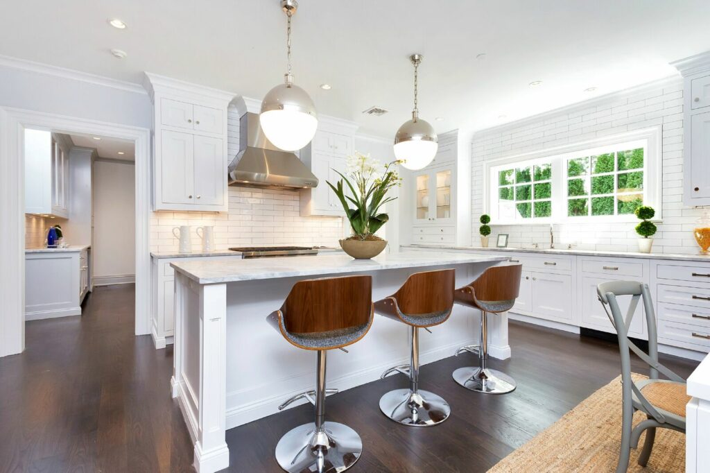 Bright Kitchen With Sleek White Cabinetry and a Large Island