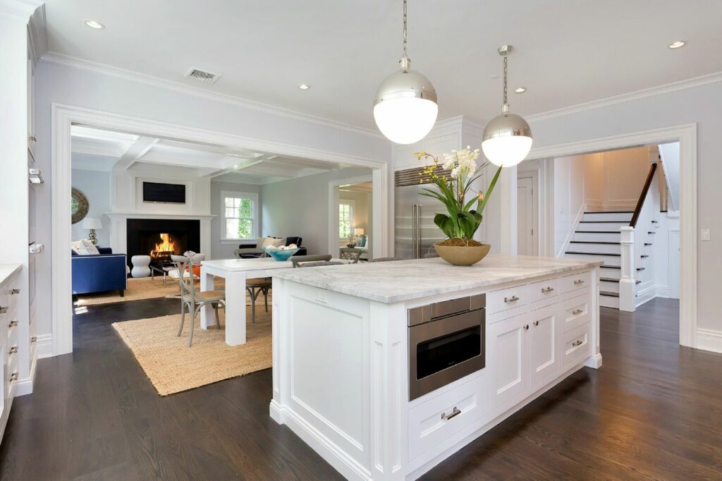 A Modern Kitchen Featuring a Central Island and Elegant Hardwood Flooring