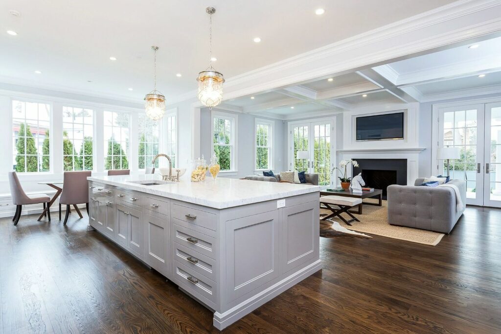 A Spacious Kitchen Featuring a Central Island and Elegant Hardwood Flooring