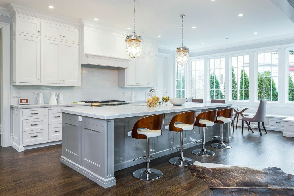 A Stylish Kitchen Showcasing White Cabinetry Paired With Elegant Wooden Flooring