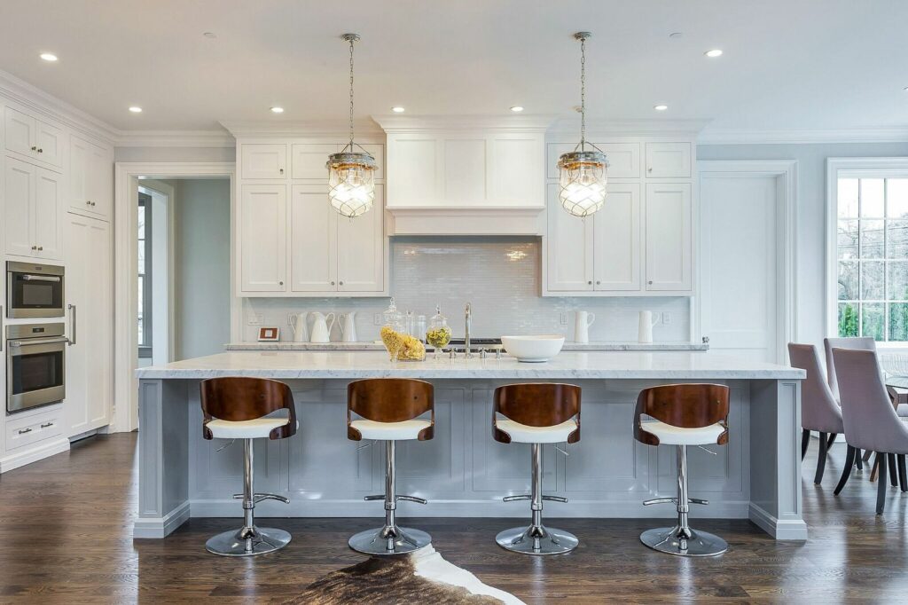 A Modern Kitchen Featuring White Cabinets and Warm Wooden Floors