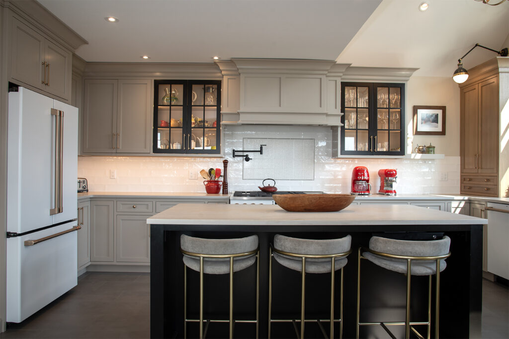 A Spacious Kitchen Showcasing a Center Island With Four Stools Arranged Around It for Dining