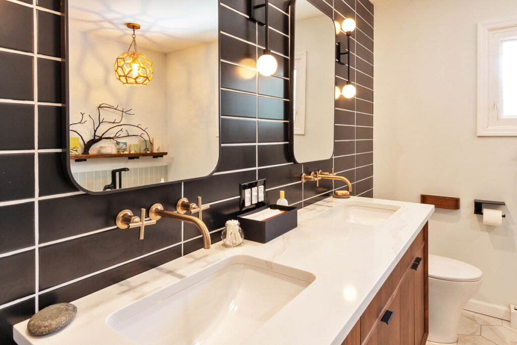 A Modern Bathroom Featuring Two Sinks and a Large Mirror Above Them