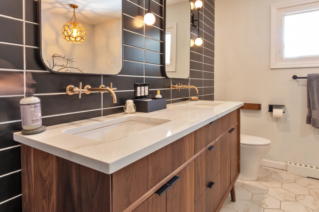 A Bathroom Featuring a Sink and Two Mirrors
