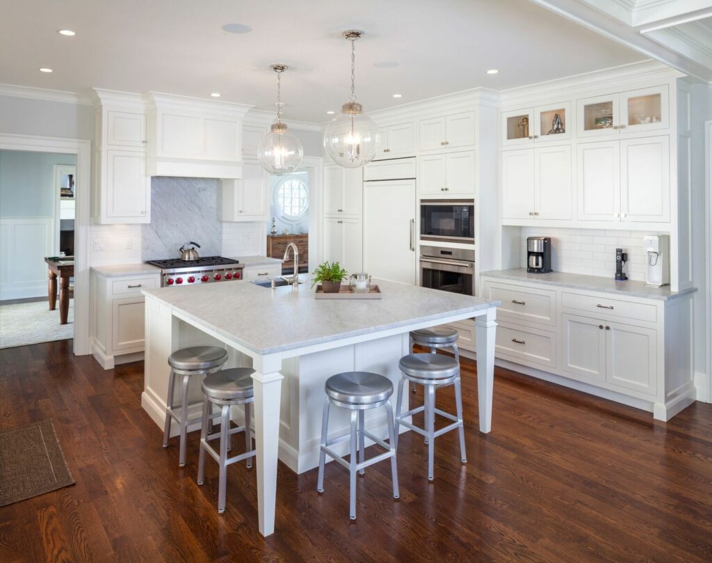 A Modern Kitchen Featuring White Cabinets and a Spacious Center Island