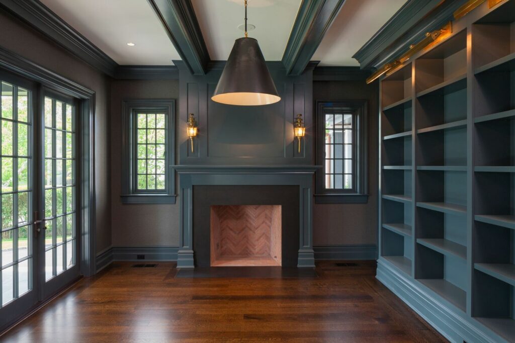 A Cozy Room Featuring Blue Walls and a Warm Fireplace