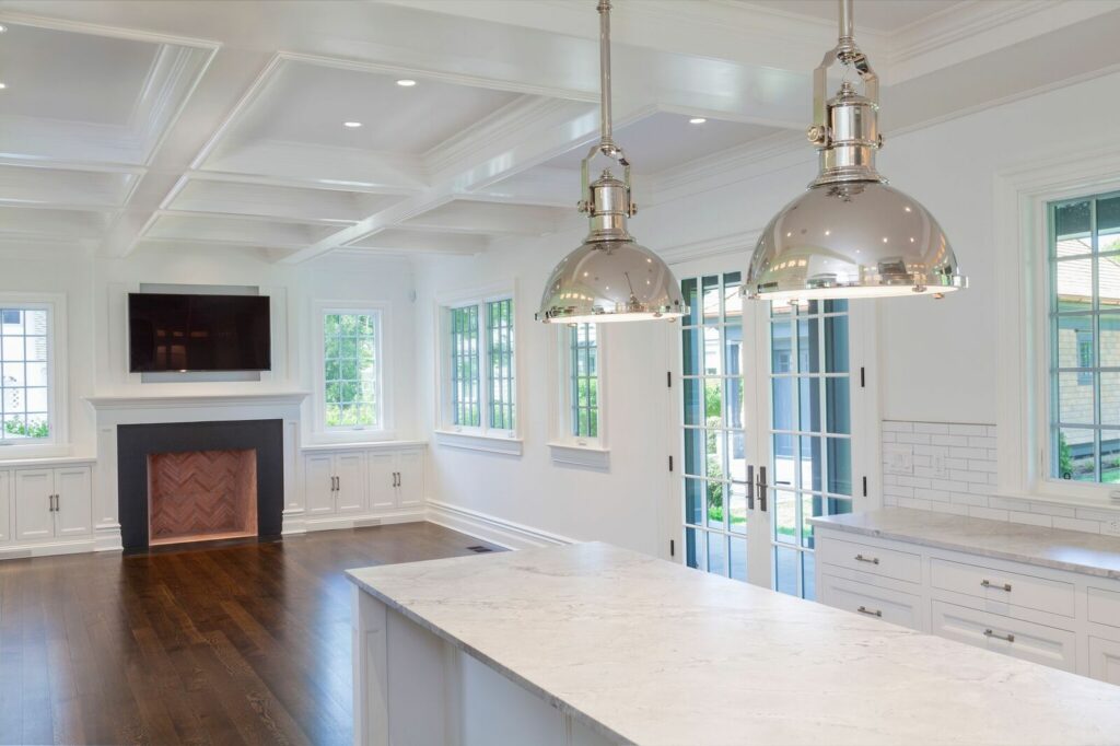 A Modern Kitchen Featuring White Cabinets and a Cozy Fireplace