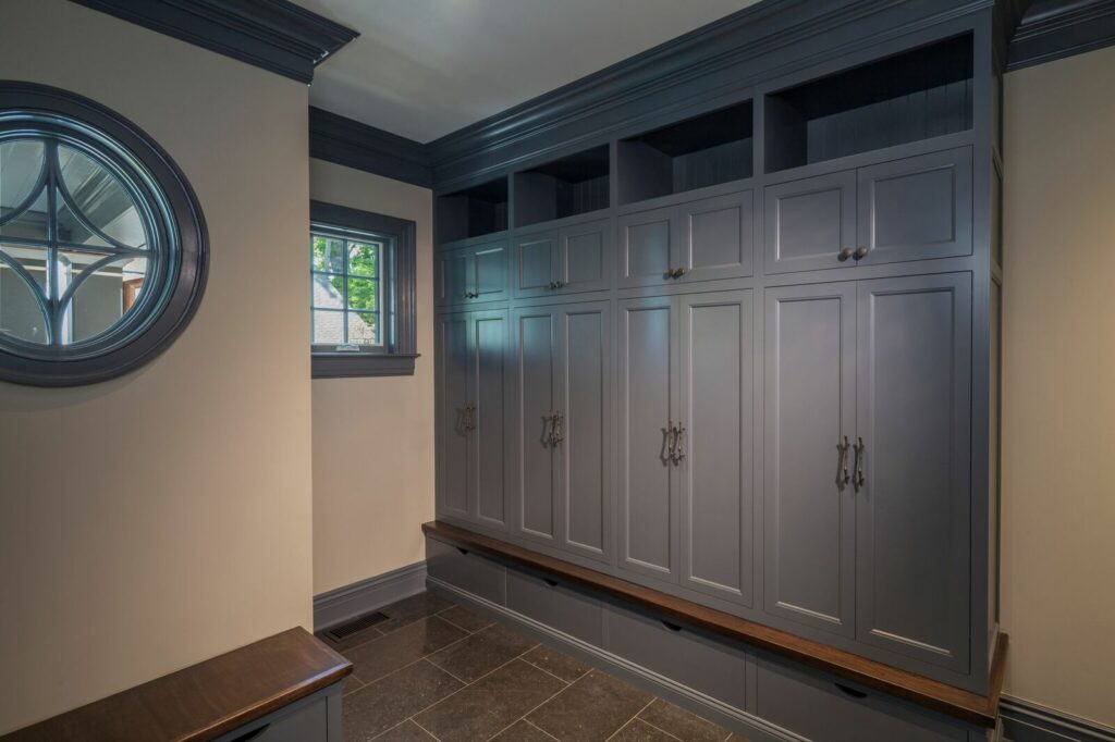 A Spacious Dark Blue Hallway Featuring a Large Mirror