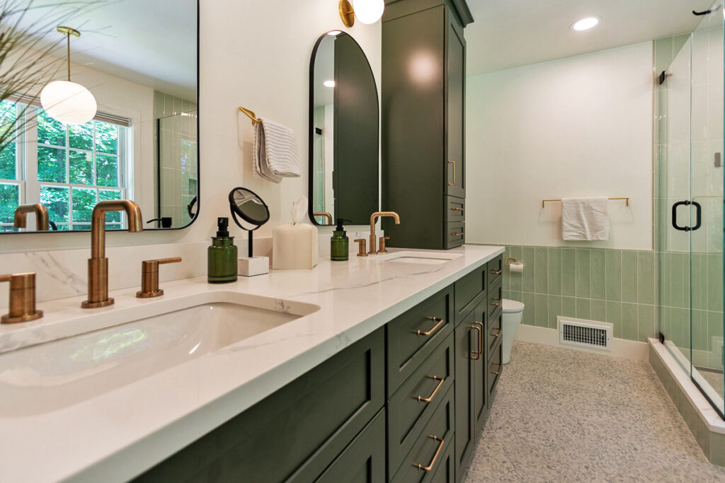 A Contemporary Bathroom With Green Cabinets