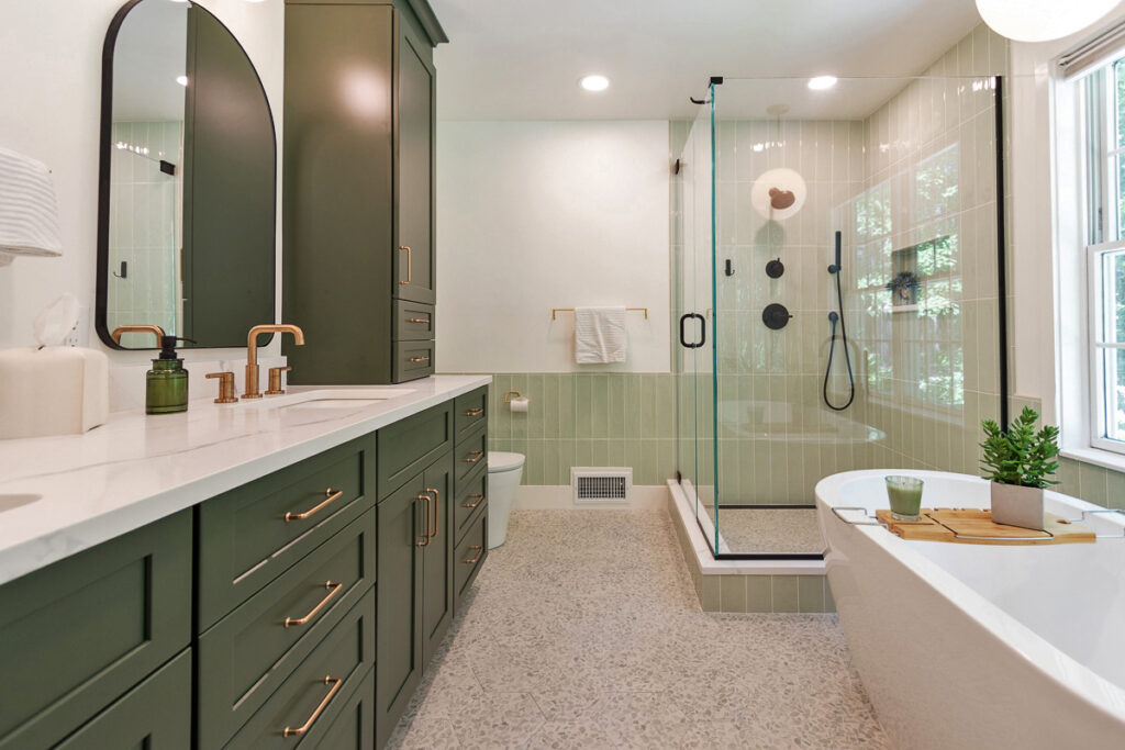 A Modern Bathroom Featuring Green Cabinets and a Spacious Walk-in Shower