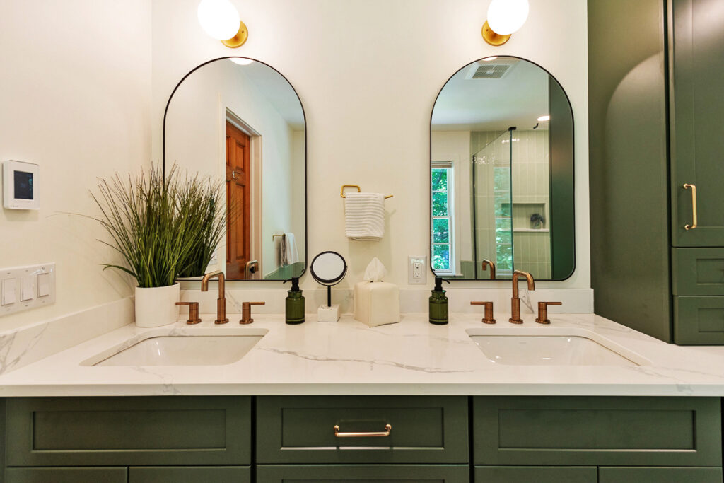 A Modern Bathroom Featuring Green Cabinets and Two Sinks