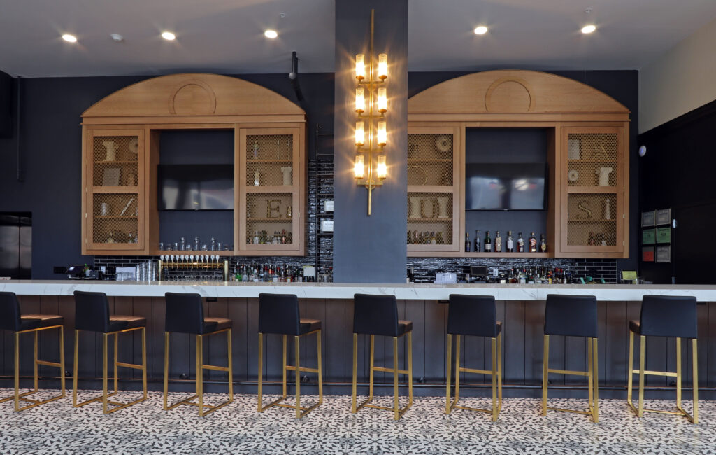 The Hotel Bar Features Elegant Black and Gold Decor