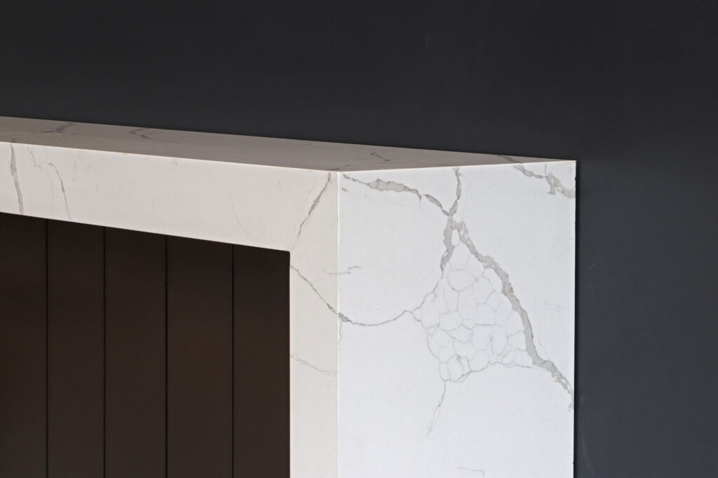 The Image Features a White Marble Fireplace