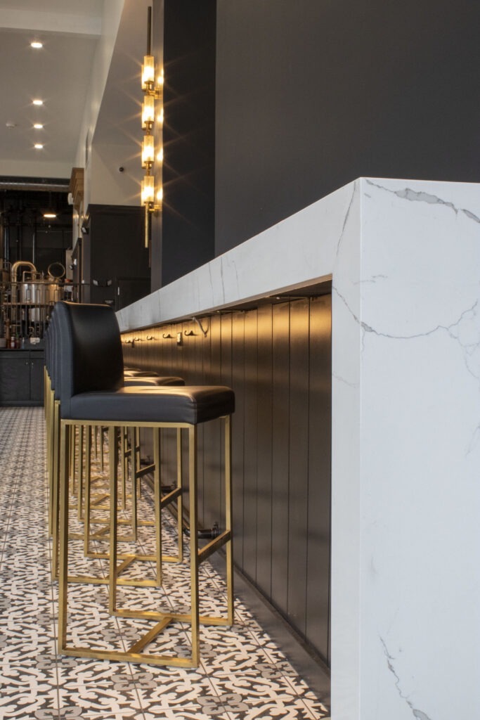 A Stylish Bar Featuring Elegant Black and Gold Chairs