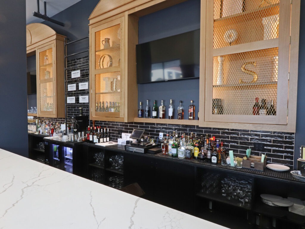 A Well-Stocked Bar Featuring a Polished Counter and Shelves