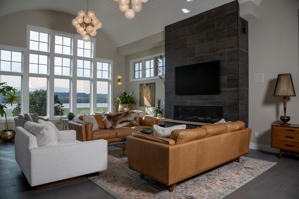living room with high ceilings, tan leather couches