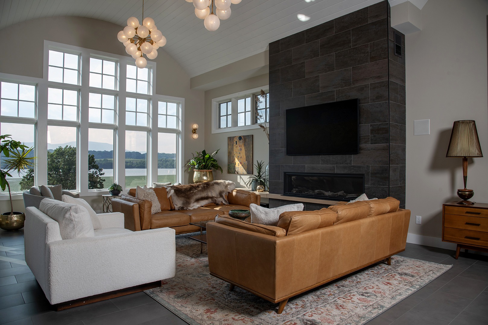 living room with high ceilings, tan leather couches