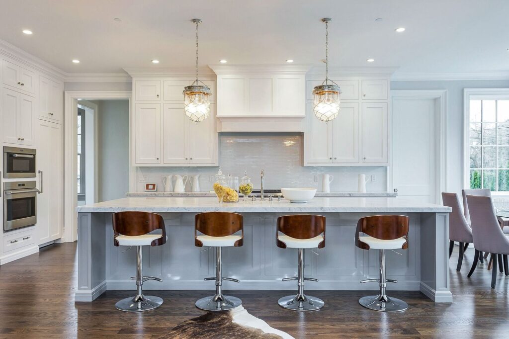 Kitchen island with two hanging lights and bar stools