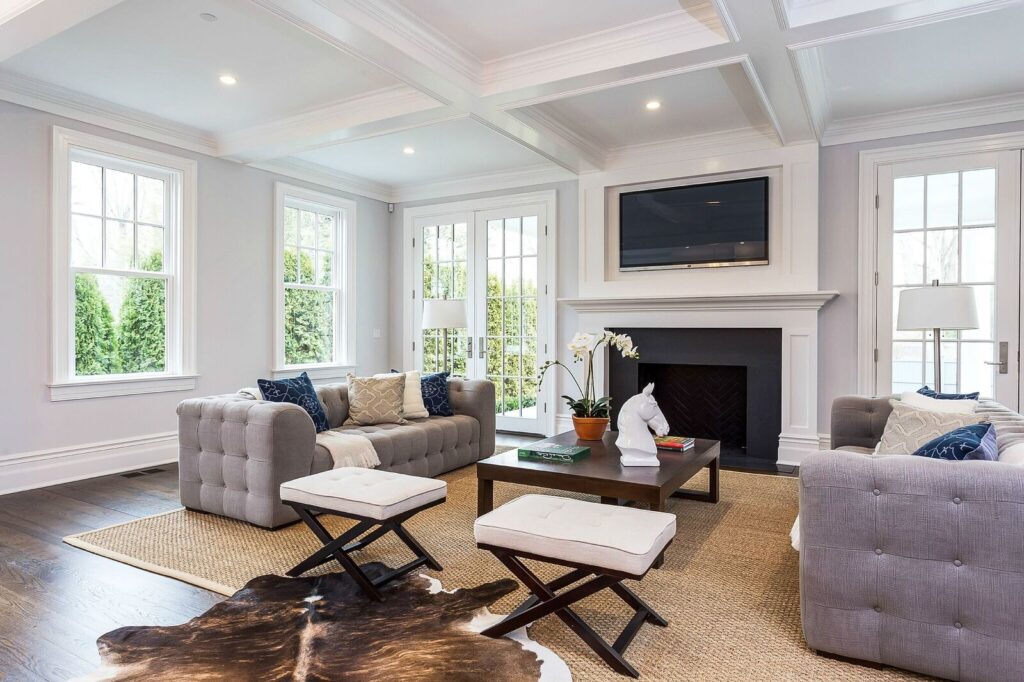 Modern living room with two grey couches and a fireplace